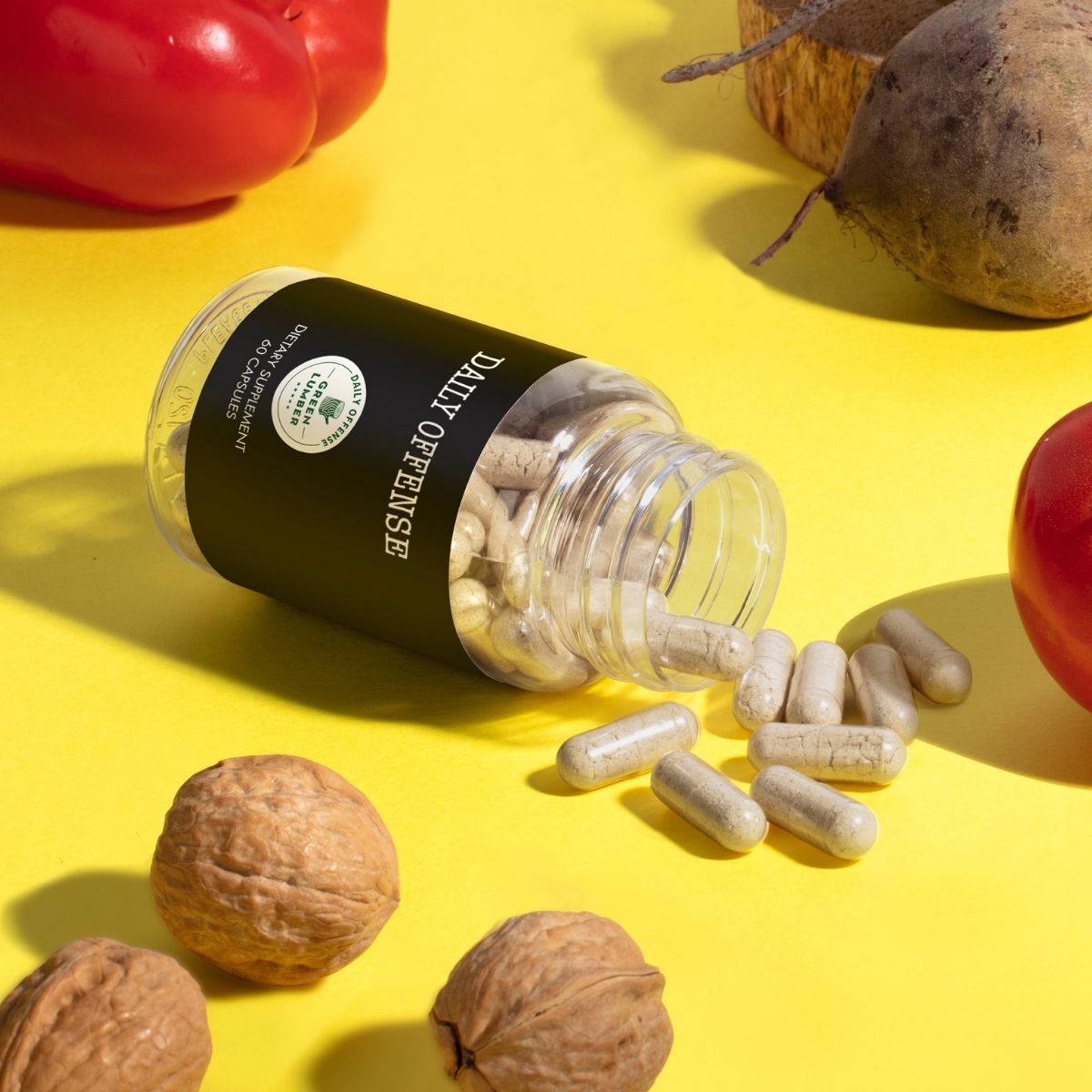 Daily Offense bottle on side with capsules spilling out on yellow background