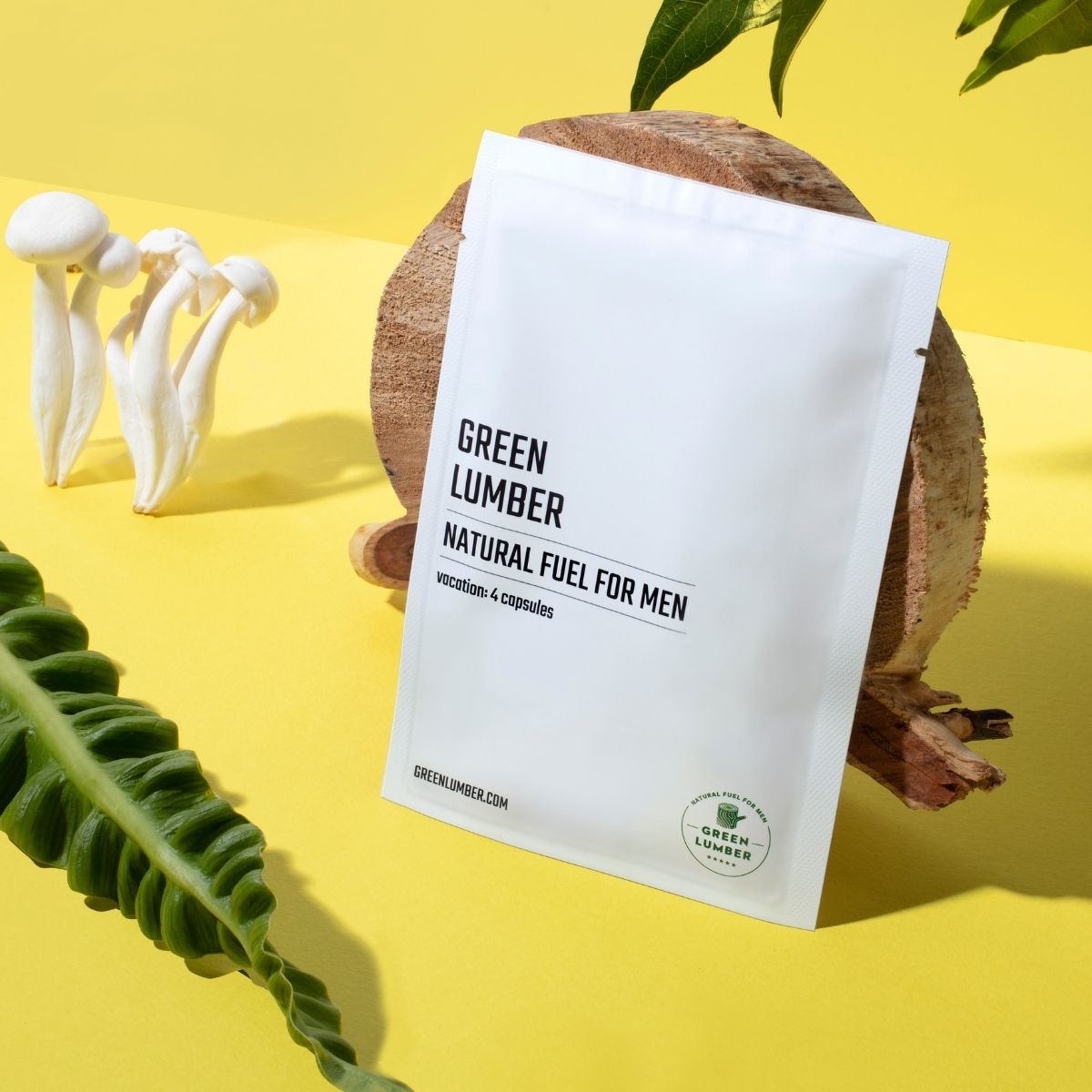 Green Lumber Natural Fuel For Men package leaning against a piece of wood on a yellow background